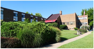 Exterior view of Clovernook Health Care LLC with landscaping