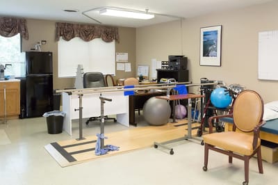 Physical therapy room with equipment in a bright space