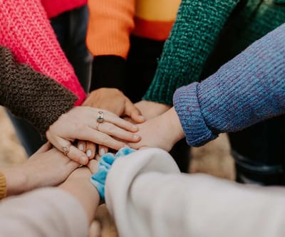 Hands of multiple individuals in a circle