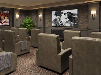 Cozy movie theater seating with a classic film playing