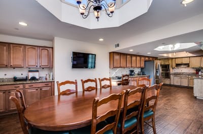Bright dining area with wooden furniture and a large table
