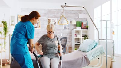 Care staff assisting a resident in a healthcare setting