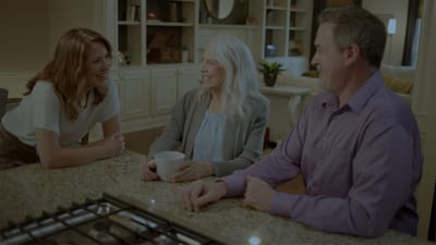 Staff and resident chatting in a common area.