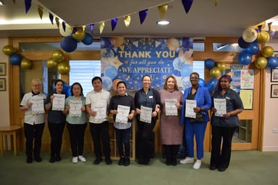Staff members celebrating with certificates