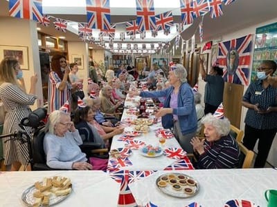 Residents enjoying a celebration with decorated tables.