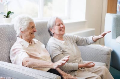Two elderly women enjoying a moment together.
