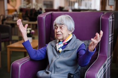 Senior resident engaging in conversation in a common area