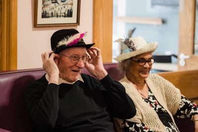 Residents enjoying hats in a common area.