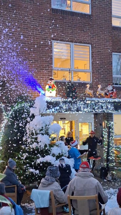 Residents enjoy a festive outdoor celebration with decorations.