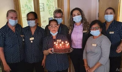 Staff celebrating with a cake and candles