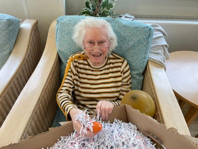 Resident engaging in an activity with shredded paper.