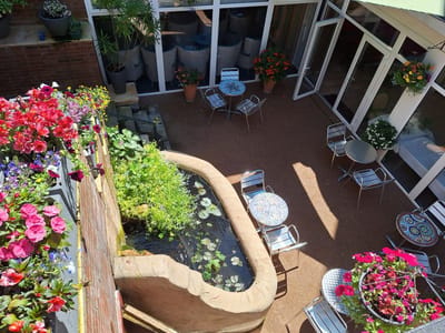Outdoor courtyard with flowers and seating