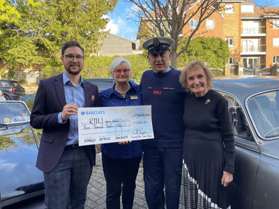 Residents presenting a check outdoors