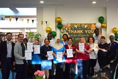 Staff and residents celebrating with certificates.