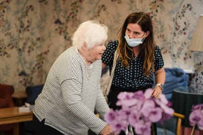 Resident and staff member interacting in common area