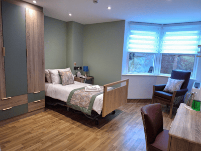 Bright, comfortable resident room with modern furnishings.