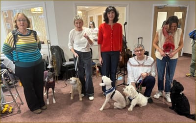 Residents and staff with therapy dogs indoors