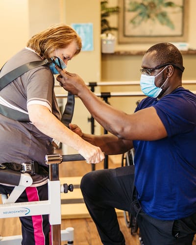 Staff assisting resident in a therapy session.
