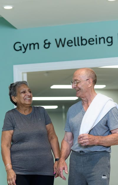 Residents smiling in a gym area