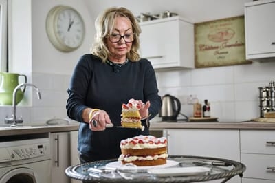 Woman preparing a cake in a kitchen