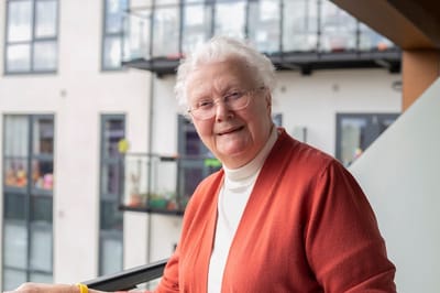 Smiling resident on a balcony
