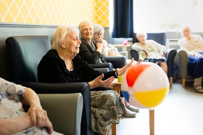 Residents enjoying an activity with a beach ball.