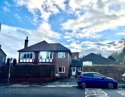 Exterior view of Glenbank Care Home with car parked