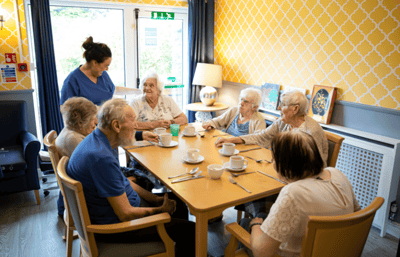 Residents enjoying a social gathering in the common area.