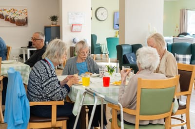 Residents enjoying a meal in the dining area.