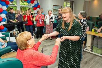 Residents and staff enjoying a lively activity together.