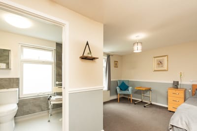 Private resident room with bathroom and seating area