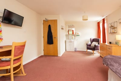 Bright private resident room with furniture and decor