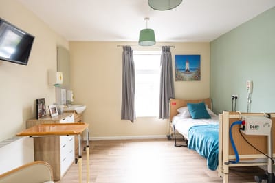 Private resident room with bed and furnishings