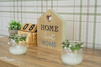 Decorative wooden sign with 'Home Sweet Home'