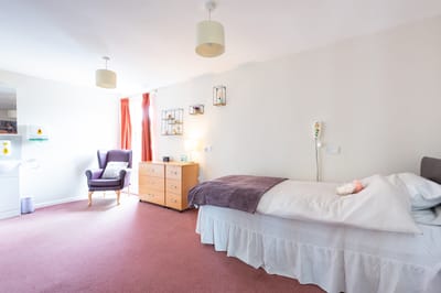 Private resident room with bed and furniture