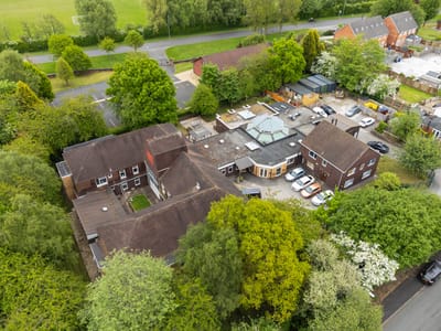 Aerial view of The Place Up Hanley facility surrounded by greenery.