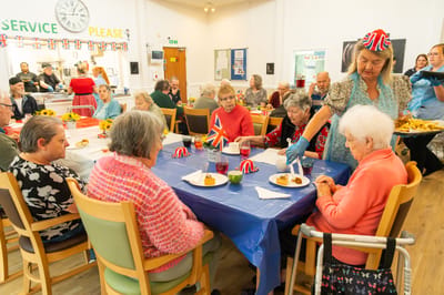 Residents enjoying a meal in a communal dining area.