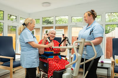 Senior resident engaging with staff in an activity