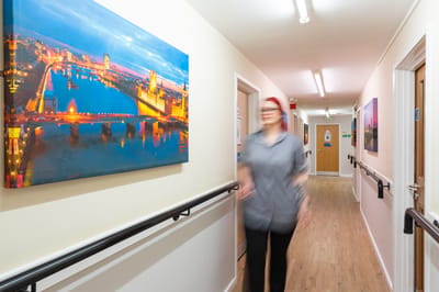 Staff member walking in facility corridor