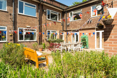 Outdoor patio decorated with flags and seating