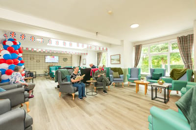 Residents relaxing in a common area with decor