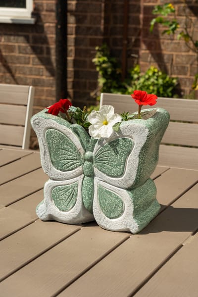 Butterfly planter with flowers on a table