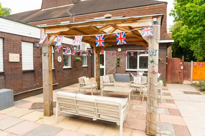 Outdoor seating area with British flags and decor.