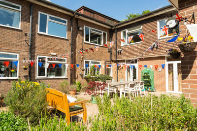 Outdoor courtyard adorned with flags and seating.