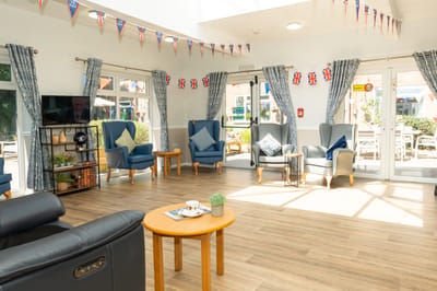 Bright common area with seating and outdoor views.