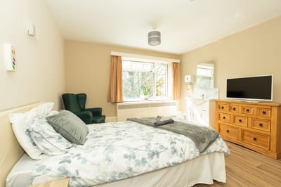 Comfortable resident room with bed and TV
