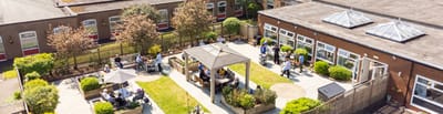 Aerial view of outdoor common area with residents and staff.