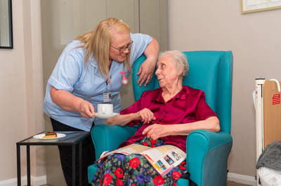 Caregiver interacting with a resident in a cozy room