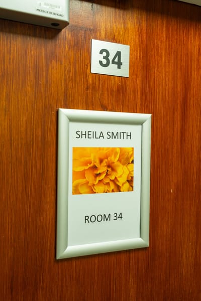 Room number sign with a floral design