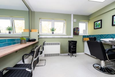 Salon space with chairs and large windows